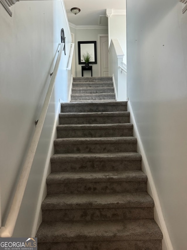 stairway featuring ornamental molding