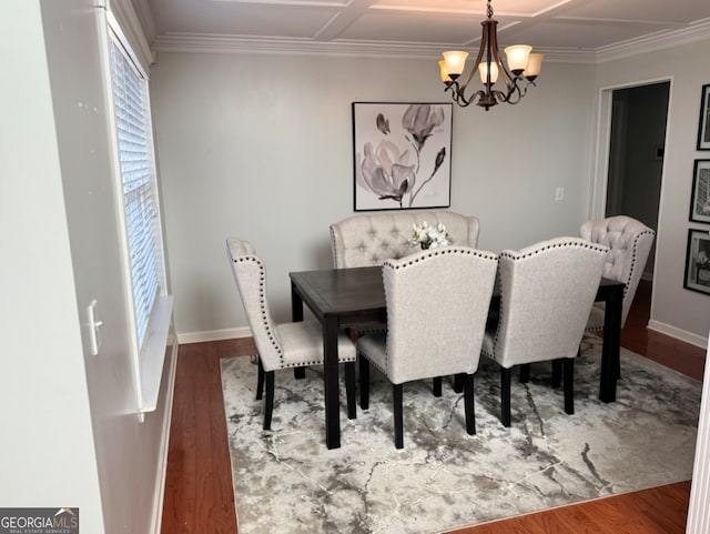 dining space with a chandelier, hardwood / wood-style floors, ornamental molding, and coffered ceiling