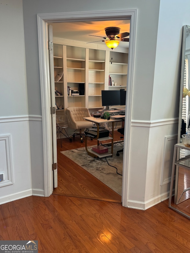 office with hardwood / wood-style flooring and ceiling fan