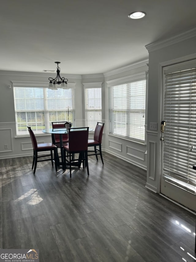 dining area with a healthy amount of sunlight, ornamental molding, and dark wood-type flooring