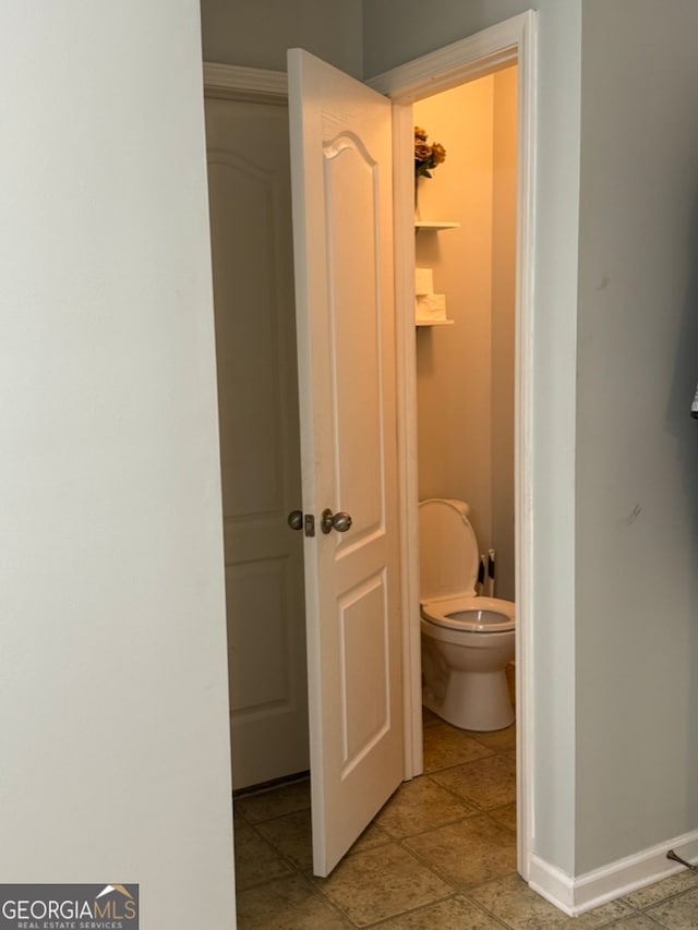 bathroom featuring tile patterned flooring and toilet