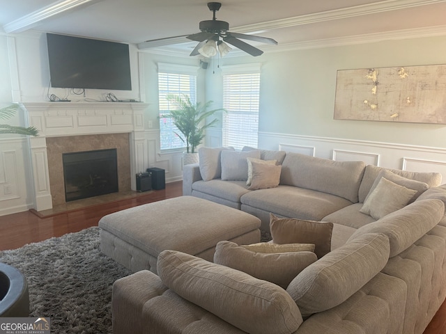 living room with crown molding, ceiling fan, and hardwood / wood-style flooring