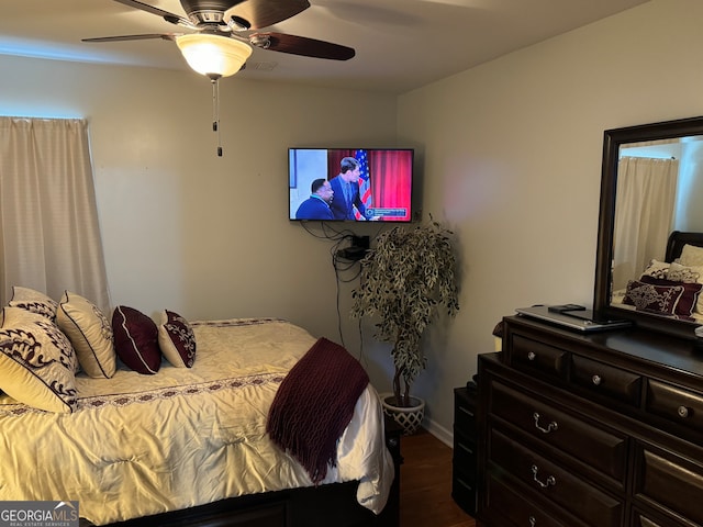 bedroom with ceiling fan and dark wood-type flooring