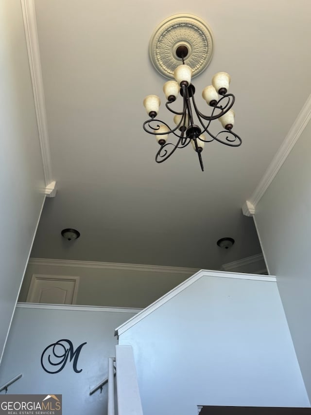 interior space featuring crown molding and an inviting chandelier