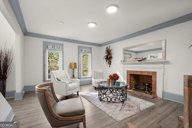 living room featuring crown molding, a brick fireplace, and hardwood / wood-style flooring