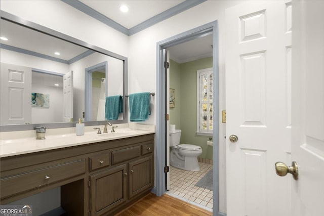 bathroom with ornamental molding, toilet, wood-type flooring, and vanity