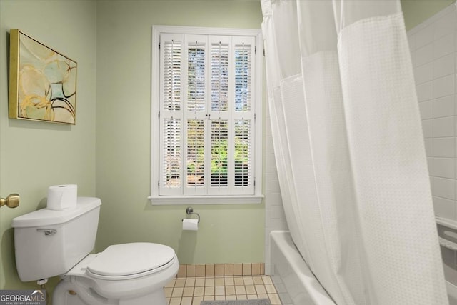 bathroom with shower / bath combination with curtain, tile patterned floors, and toilet