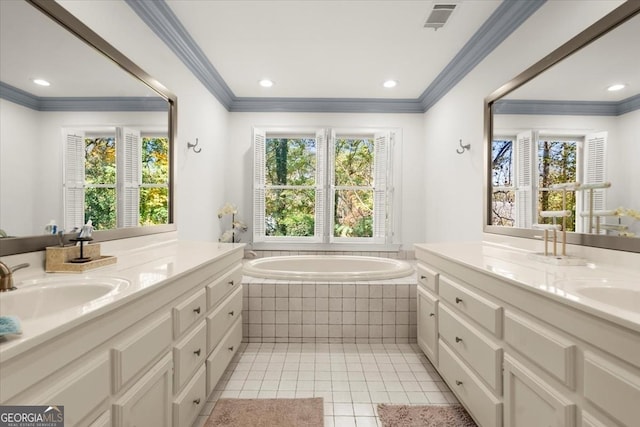 bathroom featuring plenty of natural light, tile patterned flooring, vanity, and tiled tub