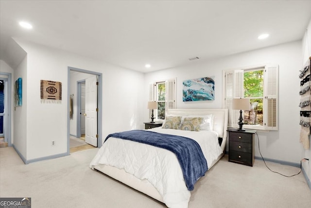 bedroom featuring light colored carpet and multiple windows