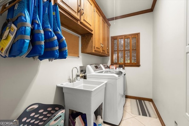 clothes washing area with sink, cabinets, light tile patterned floors, independent washer and dryer, and crown molding