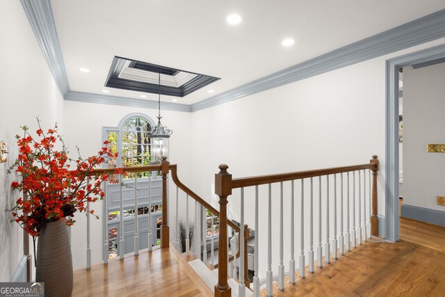 living room with ornamental molding, a brick fireplace, and wood-type flooring