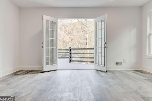 5483 Wylstream, Norcross, GA 30093 - spare room featuring light wood finished floors, recessed lighting, baseboards, and french doors