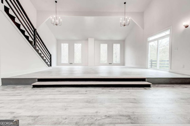 5483 Wylstream, Norcross, GA 30093 - carpeted living area with a chandelier, stairway, and high vaulted ceiling