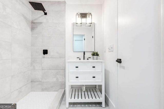 bathroom with vanity and a tile shower