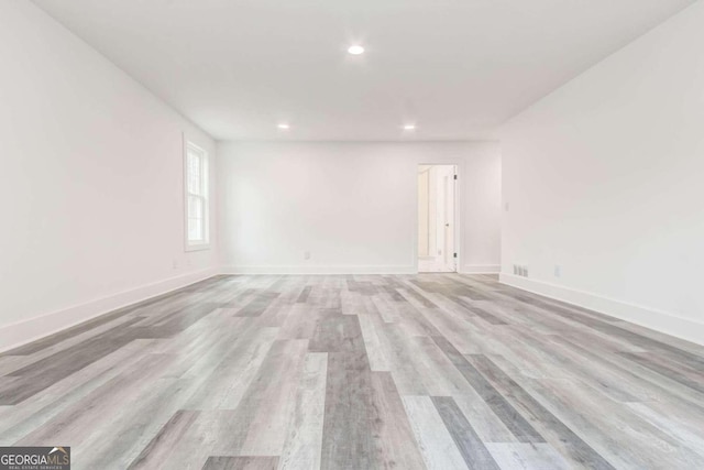 unfurnished room with light wood-type flooring