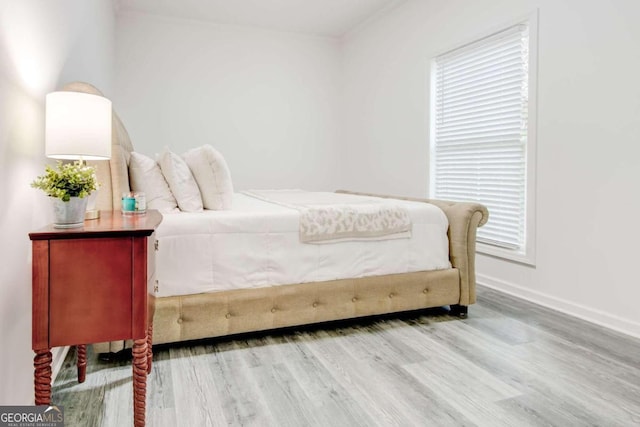 bedroom featuring hardwood / wood-style flooring and multiple windows