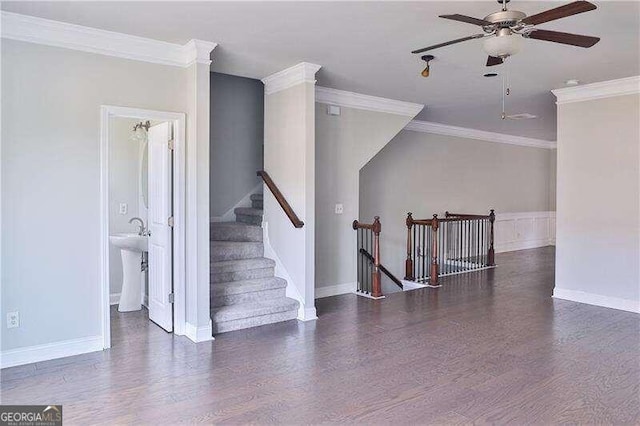 unfurnished room featuring dark hardwood / wood-style floors, ceiling fan, ornamental molding, and sink