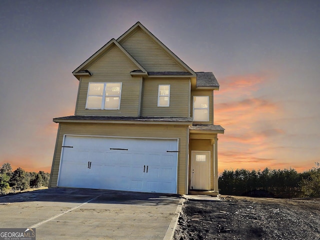 view of front of property with a garage and concrete driveway