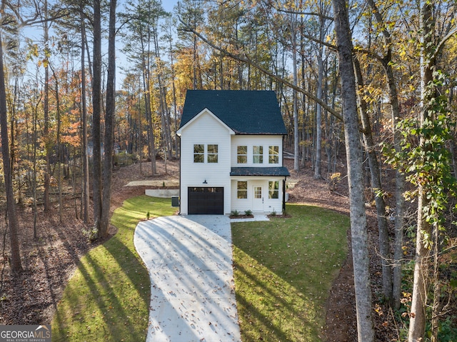 view of front of home featuring a garage and a front lawn