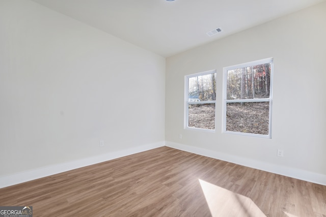 empty room with light hardwood / wood-style flooring