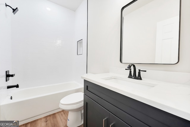 full bathroom featuring hardwood / wood-style floors, vanity, toilet, and tub / shower combination