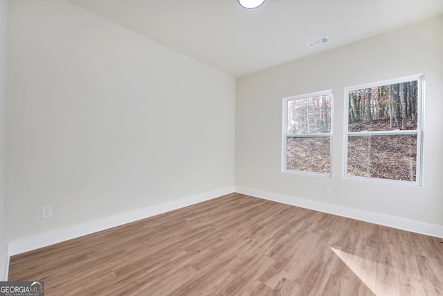 unfurnished room with light wood-type flooring