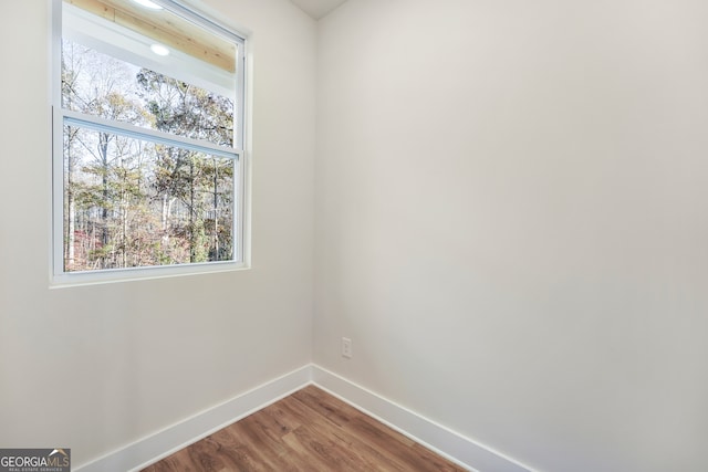 unfurnished room with wood-type flooring