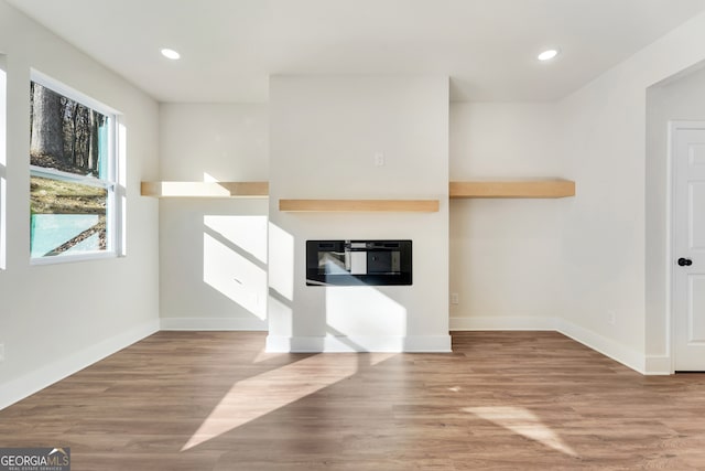 unfurnished living room featuring wood-type flooring