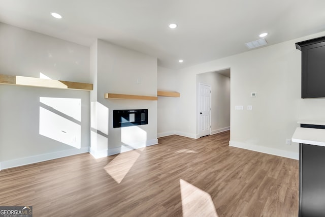 unfurnished living room with light hardwood / wood-style flooring