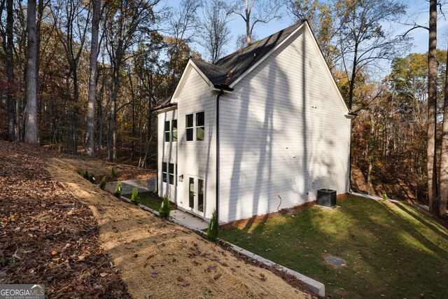 view of home's exterior featuring a yard and cooling unit