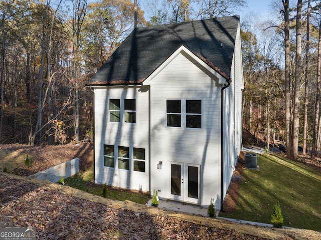 back of property featuring a yard, french doors, and central AC unit