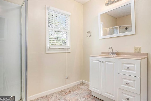 bathroom with vanity and a shower with door