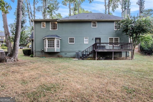 back of property featuring a wooden deck, a yard, and cooling unit