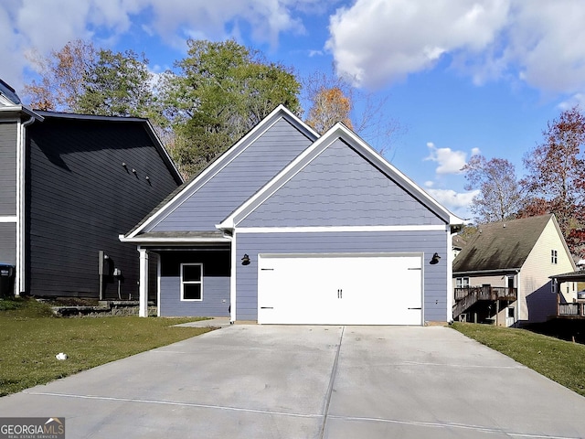 view of front of property with a front yard and a garage