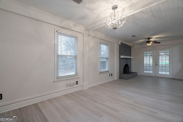 unfurnished living room with a fireplace, beam ceiling, wood finished floors, and wooden ceiling