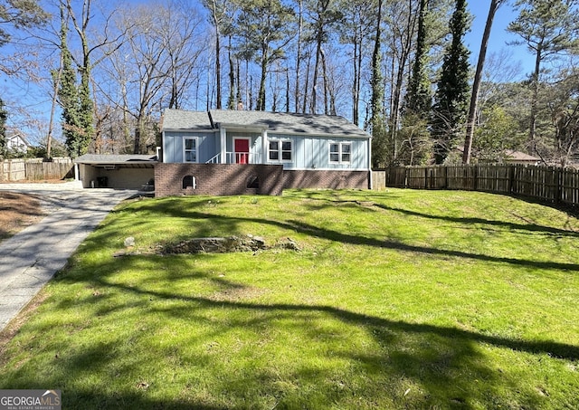 view of front of property with a front yard, brick siding, and fence