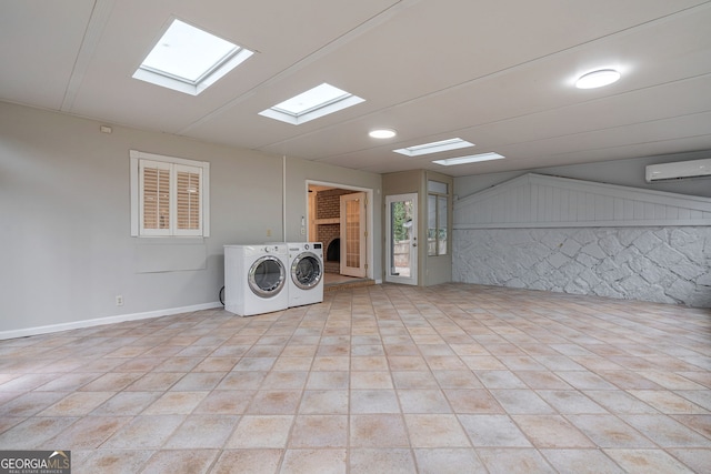 laundry room with laundry area, independent washer and dryer, and a wall unit AC