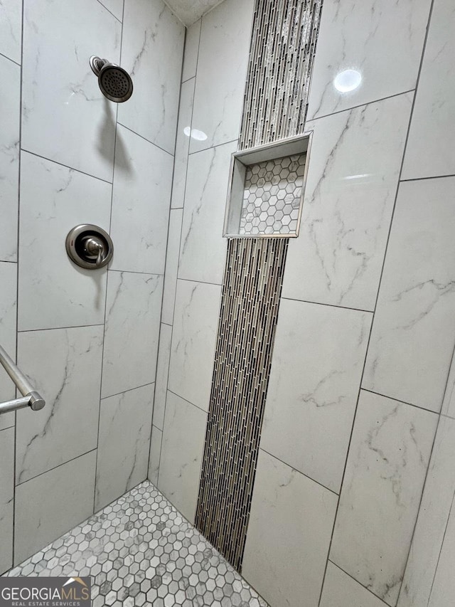 bathroom with tiled shower