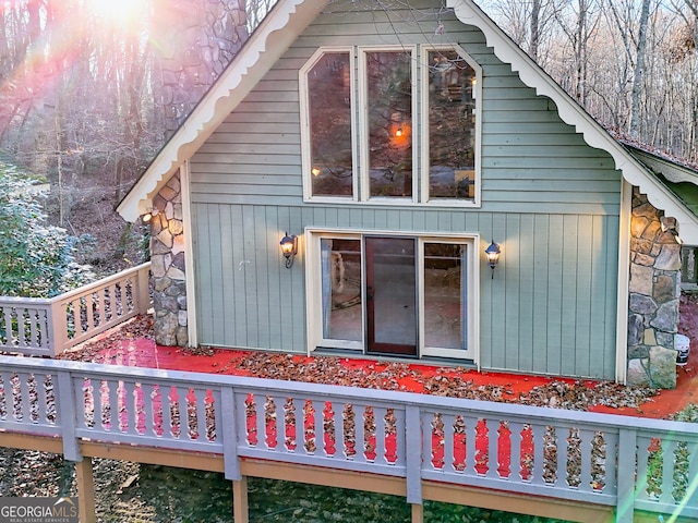 view of property exterior with a wooden deck