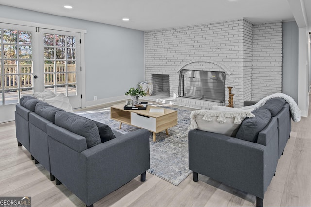 living room with a fireplace and light hardwood / wood-style flooring