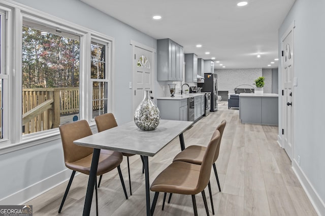 dining room with light hardwood / wood-style flooring and sink