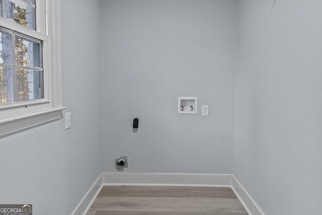 laundry room with hookup for an electric dryer, light hardwood / wood-style floors, and hookup for a washing machine