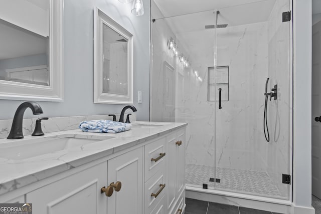 bathroom with tile patterned flooring, vanity, and walk in shower