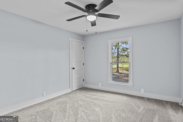 carpeted empty room featuring ceiling fan