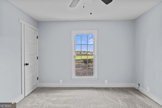 empty room featuring carpet flooring and ceiling fan