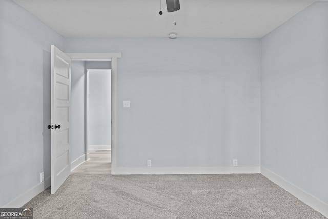 empty room featuring light carpet and ceiling fan