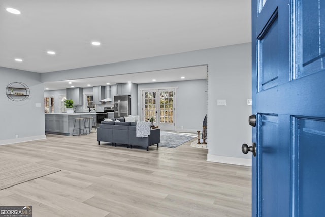 living room with light hardwood / wood-style flooring and french doors