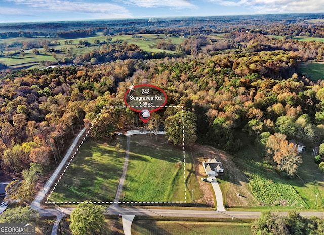 birds eye view of property with a rural view