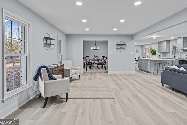 living room featuring light hardwood / wood-style floors and sink