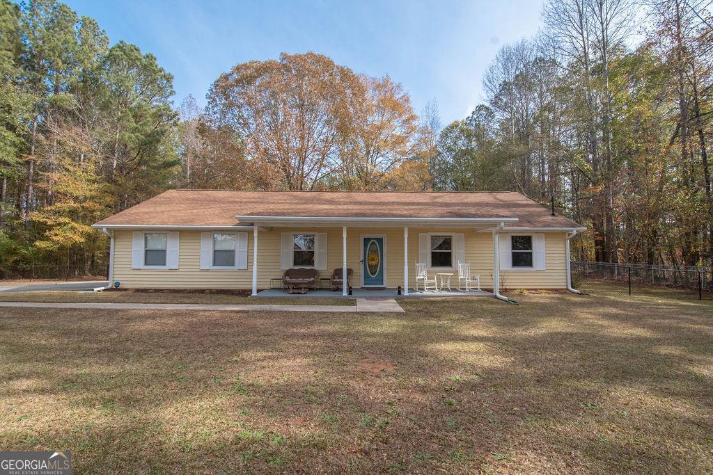 single story home featuring a patio and a front yard